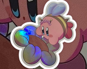May include: A pink and yellow bee-themed sticker with a holographic iridescent finish. The bee has a flower crown and is holding a brown object.