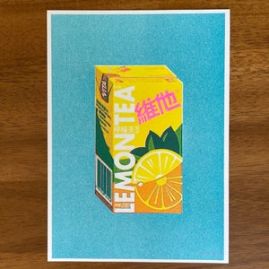 May include: A yellow and green box of lemon tea with the text 