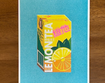 May include: A yellow and green box of lemon tea with the text "LEMONTEA" and "綠地" in pink. The box has a picture of a lemon slice on it.