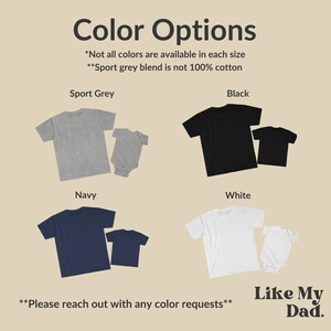 May include: Image showcasing t-shirts and baby onesies in various colors: sport grey, black, navy, and white. The text "Color Options" is at the top, with additional text about color availability and a brand logo.