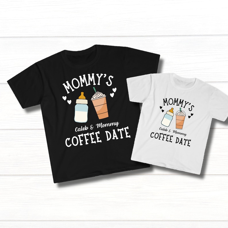 May include: Two black and white t-shirts with the text "Mommy's Caleb & Mommy Coffee Date" and a graphic of a baby bottle and a coffee cup.