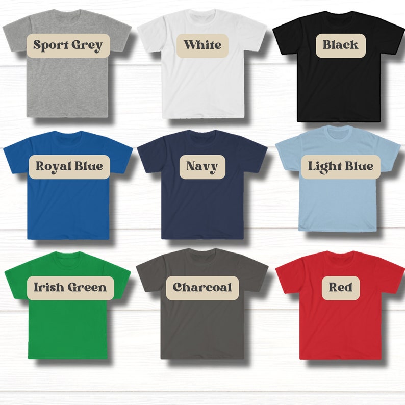 May include: Nine t-shirts in different colors, each with a color name label in a brown rectangle. The colors are: Sport Grey, White, Black, Royal Blue, Navy, Light Blue, Irish Green, Charcoal, and Red.