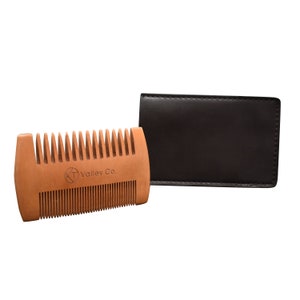 May include: A wooden beard comb with a brown leather case. The comb has the text "KT Valley Co." engraved on it.