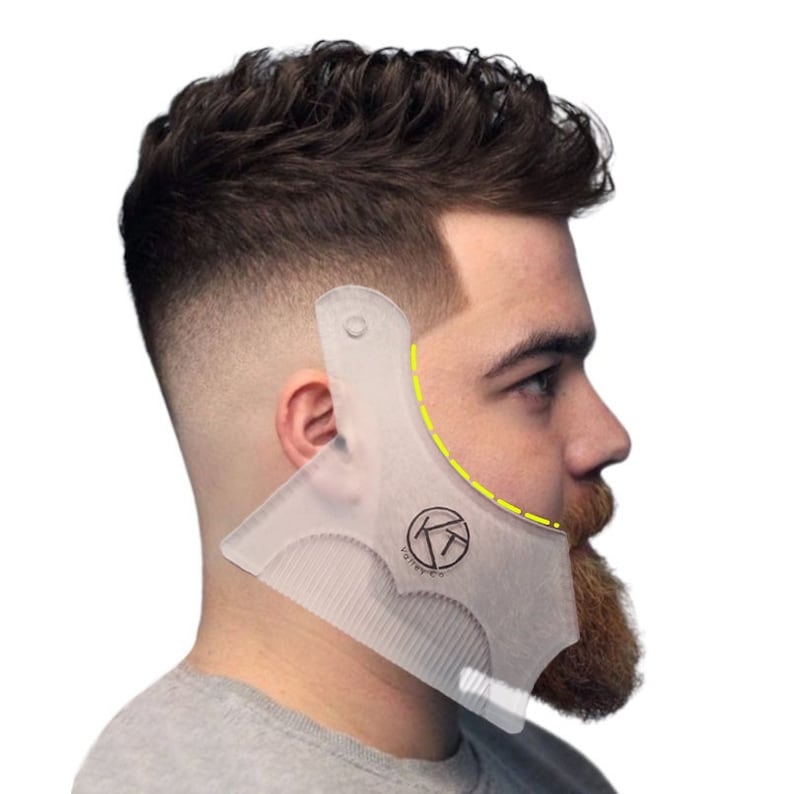 May include: A clear plastic beard shaping tool with a comb and a curved edge. The tool is being used to shape a man's beard. The tool has the text "Varies-Tee" printed on it.
