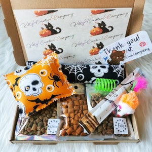 A cat gift box made with Halloween themed fabric which contains treats and handmade strong smelling catnip toys which cats will love