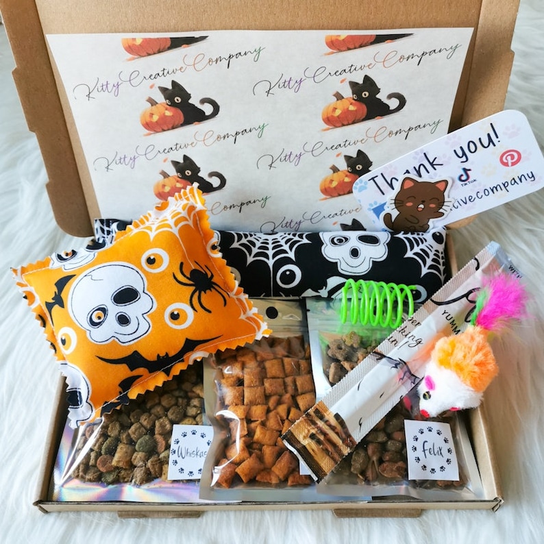 A cat gift box made with Halloween themed fabric which contains treats and handmade strong smelling catnip toys which cats will love