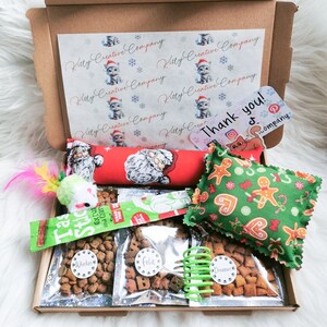 A cat gift box made with Christmas themed fabric which contains treats and handmade strong smelling catnip toys which cats will love