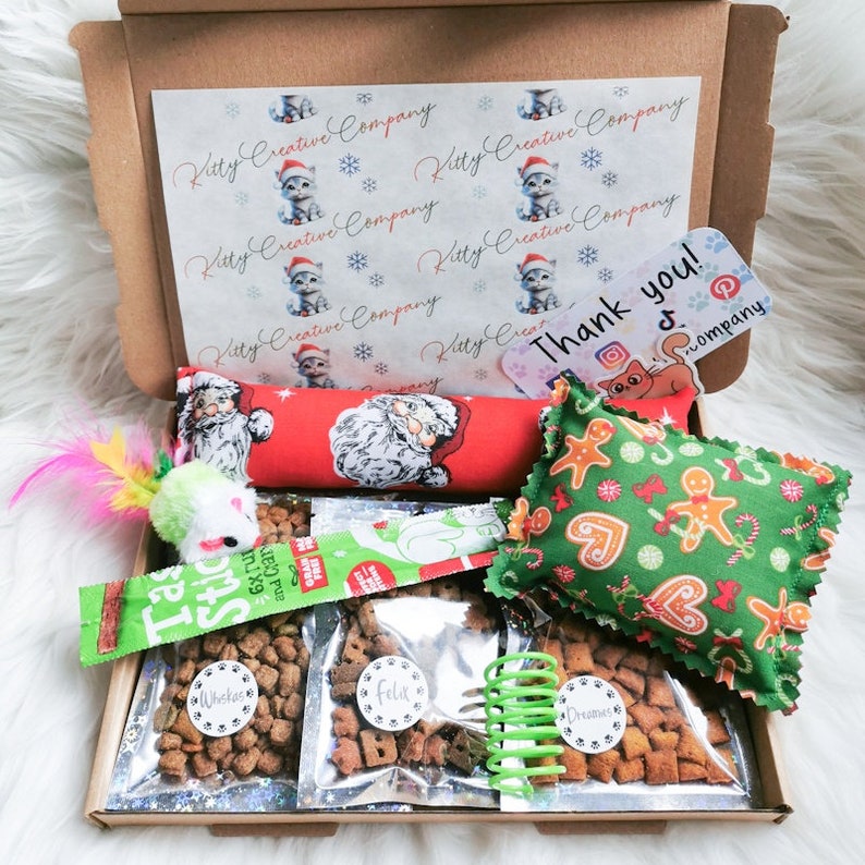 A cat gift box made with Christmas themed fabric which contains treats and handmade strong smelling catnip toys which cats will love