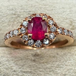 18kt rose gold ring with a brilliant-cut ruby in the center and 0.50 ct natural diamonds