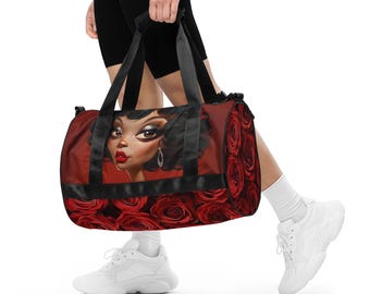 May include: A red duffel bag featuring a stylized illustration of a woman with dark hair and red lipstick. The bag is adorned with red roses and black accents, perfect for carrying gym essentials or travel items.