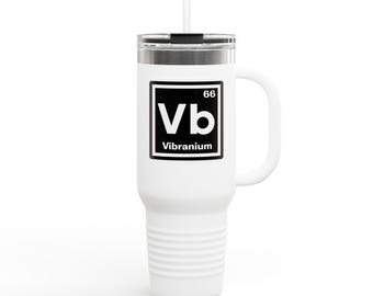 May include: White stainless steel travel mug with a black handle and lid. The mug has a black and white graphic of a periodic table element with the symbol "Vb" and the text "Vibranium" underneath.
