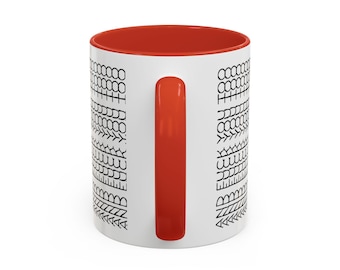 May include: White ceramic coffee mug with a red interior and handle. The exterior features a repeating black pattern of various shapes. The mug is designed for hot or cold beverages.