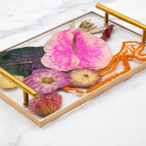 Tropical bouquet preserved in resin serving tray with gold handles and gold painted edge