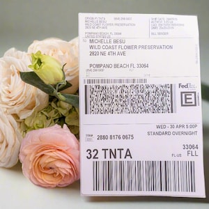 May include: A white FedEx shipping label with the text "WILD COAST FLOWER PRESERVATION" and the address "2820 NE 4TH AVE POMPANO BEACH FL 33064". The label also includes the tracking number "2880 8176 0675" and the text "32 TNTA".