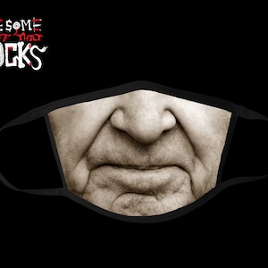 May include: Black face mask featuring a sepia-toned close-up of a person's nose and mouth. The mask has the text "AWESOME STUFF THAT ROCKS" in white and red lettering on the upper left corner.