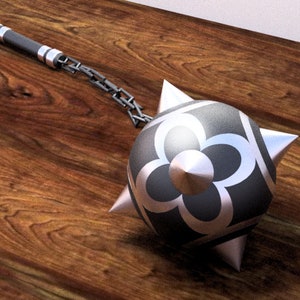 May include: A silver spiked ball with a black center and a chain attached to a silver handle. The ball has a decorative flower design.