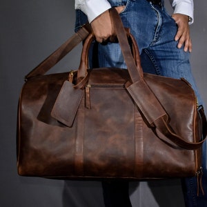 Leather duffel bag for men is a must have for weekend getaway or gym. This leather weekender bag comes with separate shoe compartment to keep used shoes or clothes. The duffle bag has a small zipper pocket on the outside and a trolley sleeve at back.