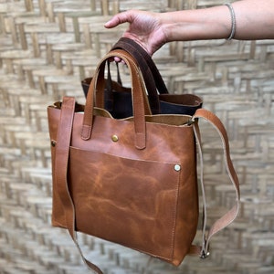 The beautiful leather comes with a two tone effect which is a characteristic of full grain leather which is highest quality and the most desirable leather. The bag comes with an optional crossbody strap. You can buy the bag with or without the strap.