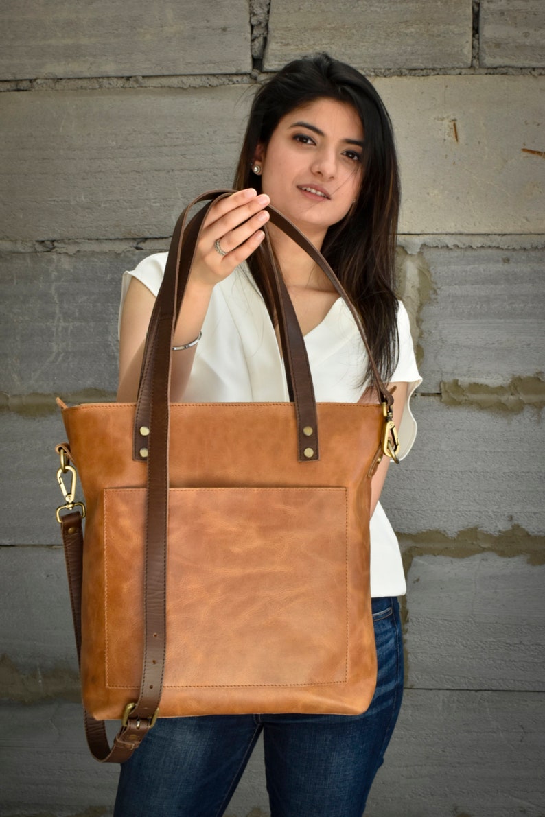 Leather tote bag for women is the perfect large work tote bag. The leather purse is made from full grain genuine leather and is big enough to hold all your travel essentials for the weekend. The shopper tote can be personalized with initials or name