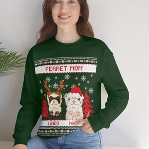 May include: Green Christmas jumper with a festive design featuring two ferrets wearing Santa hats and reindeer antlers. The jumper has the text "Ferret Mom" and the names "Lingo" and "Nala" printed on it.
