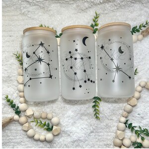 May include: Three frosted glass jars with bamboo lids and black constellation designs. The jars are decorated with a crescent moon, stars, and the text "CREATIONS BY KRISTA LEE SUBLIMATION DESIGNS".