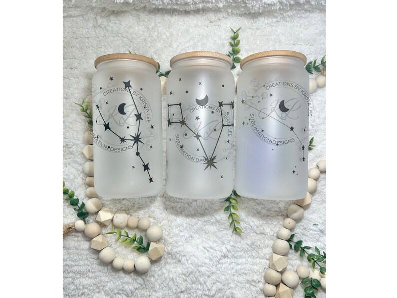 May include: Three frosted glass jars with bamboo lids, each featuring a different constellation design and the text "CREATIONS BY KRISTA LEE" and "SUBLIMATION DESIGNS".