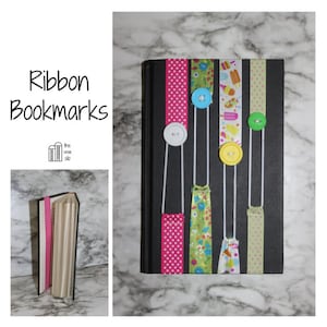 May include: A black book with colorful ribbon bookmarks. The ribbons are adorned with buttons and various patterns, including polka dots and floral designs. The text "Ribbon Bookmarks" is displayed in the upper left corner.