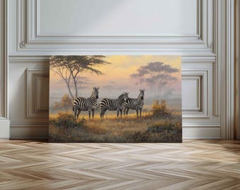 May include: A canvas print depicting three zebras standing in a grassy field under a warm, colorful sky. The artwork features a serene landscape with trees and a soft, painterly style, evoking a sense of the African savanna.