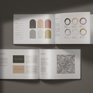May include: Open book mockup showcasing a brand guide for a company named "Bloom Adair". The guide features colour palettes, brand patterns, and business card mockups. The colour palette includes shades of brown, grey, and beige. The brand pattern is a simple, elegant floral design. The business card mockups display the company name in a straightforward, sans-serif font.
