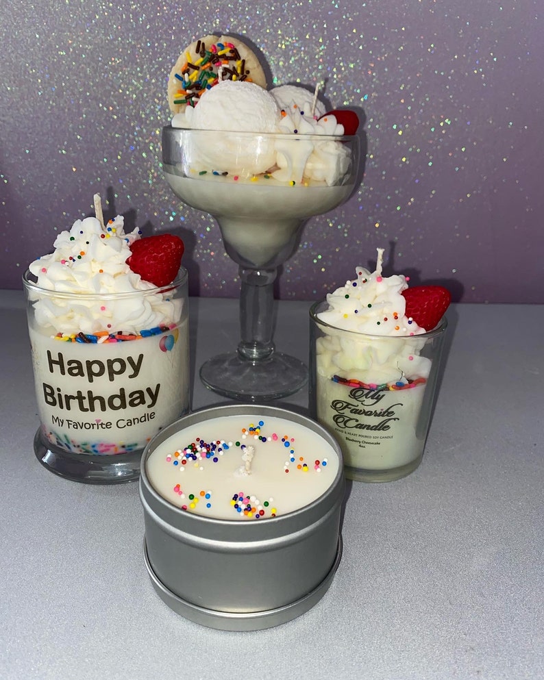 May include: Three candles in glass jars and a tin container. The candles are topped with white frosting and colorful sprinkles. The glass jars have labels that say "Happy Birthday My Favorite Candle" and "My Favorite Candle".