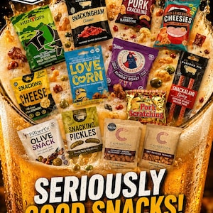 May include: A collection of various snack pouches including beef biltong, pork crackling, cheese, corn, pickles, and nuts arranged over a large glass of beer. The image features text including The Dandy Snack Club, Seriously Good Snacks, and DandySnacks.com.