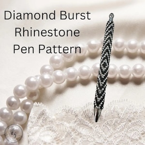 May include: A black and silver rhinestone pen with a diamond burst pattern. The pen is displayed on a white surface with a string of pearls and the text "Diamond Burst Rhinestone Pen Pattern".