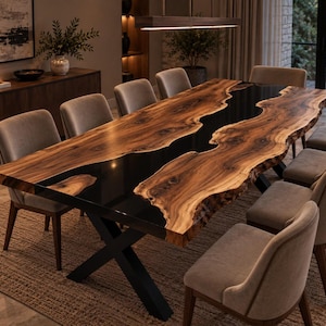 May include: A large dining table featuring two thick slabs of natural wood with a live edge, separated by a glossy black resin river inlay. The table is supported by a black metal X-shaped base and is surrounded by eight upholstered chairs.