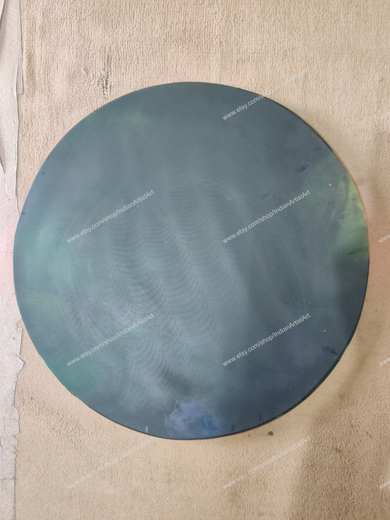 May include: A round, dark green, glass plate with a slightly textured surface. The plate has a website address printed on it: www.etsy.com/shop/indianArtistArt.