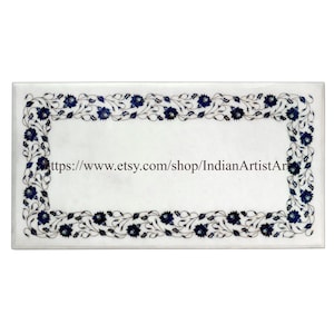 May include: White marble tabletop with a blue and white floral inlay border. The border is made of small pieces of marble and lapis lazuli. The text "https://www.etsy.com/shop/IndianArtistArt" is visible in the center of the tabletop.