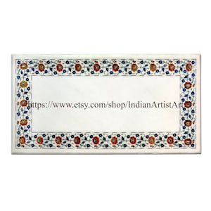 May include: White marble tabletop with a floral border design. The border features red, orange, blue, and green flowers and leaves. The text "https://www.etsy.com/shop/IndianArtistArt" is visible in the center of the tabletop.