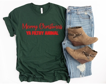 May include: A dark green t-shirt with the text "Merry Christmas Ya Filthy Animal" in red lettering.