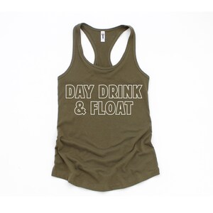 May include: A green tank top with the text "DAY DRINK & FLOAT" in white outlined letters.