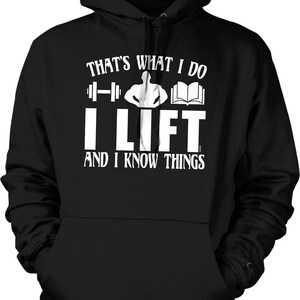 May include: Black hooded sweatshirt with white text that reads "That's what I do I lift and I know things". The text is accompanied by a graphic of a weightlifter, a barbell, and a book.