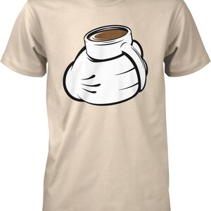 May include: A beige t-shirt featuring a cartoon graphic of a white gloved hand holding a coffee cup filled with brown liquid. The graphic has black outlines and is centered on the shirt.