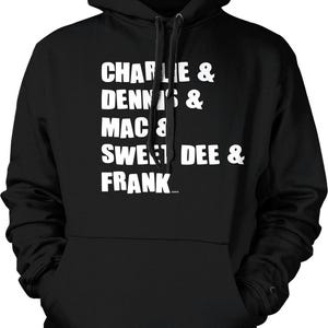 May include: Black hooded sweatshirt with white text that reads "Charlie & Dennis & Mac & Sweet Dee & Frank".