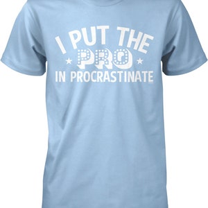 May include: Light blue t-shirt with white text that reads "I put the PRO in procrastinate".