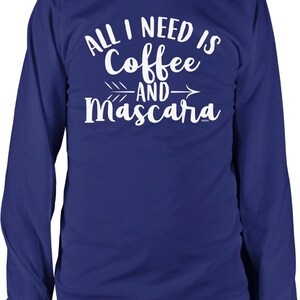 May include: A royal blue long-sleeved t-shirt with white text that reads "All I need is Coffee and Mascara".