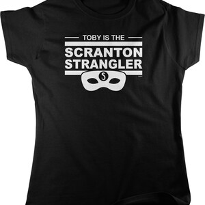 May include: Black t-shirt with white text that reads "Toby is the Scranton Strangler" with a white mask with an "S" in the middle.