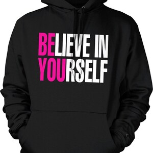 May include: Black hooded sweatshirt with the text "BELIEVE IN YOURSELF" in white and pink lettering.