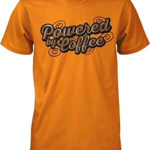 May include: Orange t-shirt with the text "Powered by Coffee" in brown lettering with swirls.
