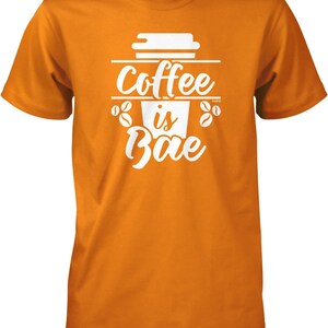 May include: Orange t-shirt with a white graphic of a coffee cup and the text "Coffee is Bae".