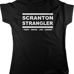 May include: Black t-shirt with white text that reads "Scranton Strangler - Toby - Mose - Jim - Creed -"