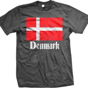 May include: A dark gray t-shirt with a distressed red and white Danish flag and the word "Denmark" printed in white.