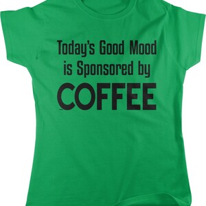 May include: Green t-shirt with the text "Today's Good Mood is Sponsored by COFFEE" in black.